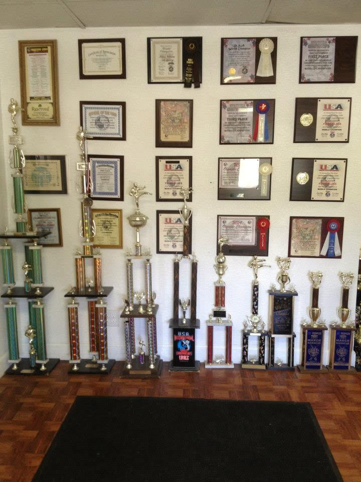 Wall of championship trophies, plaques, and certificates