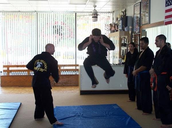 Student performing a jumping kick