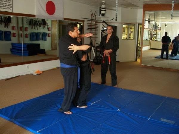 Instructor demonstrating technique on the mat
